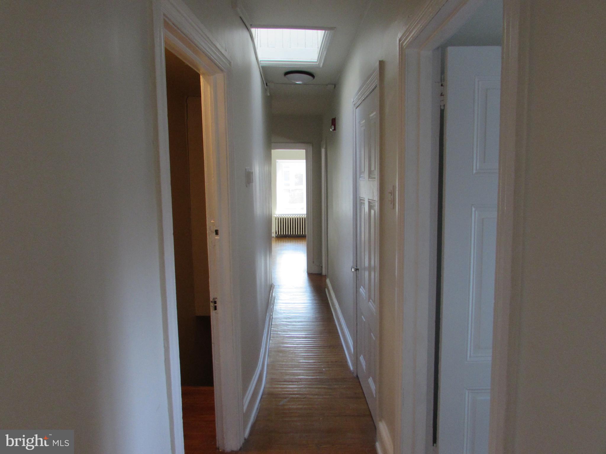 5903 Greene Street, Unit 3 Philadelphia, PA 19144 - Photo 16 of 19 a view of a hallway with wooden floor