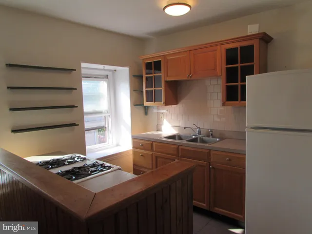 a kitchen with stainless steel appliances a stove and a refrigerator