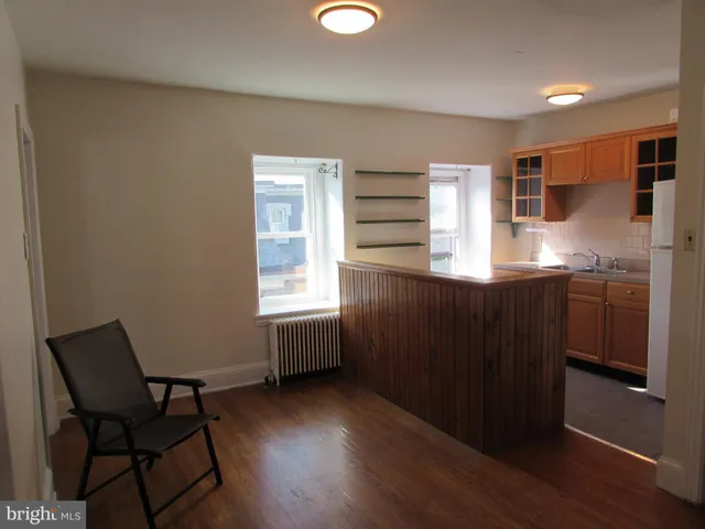 a kitchen with a sink cabinets and wooden floor