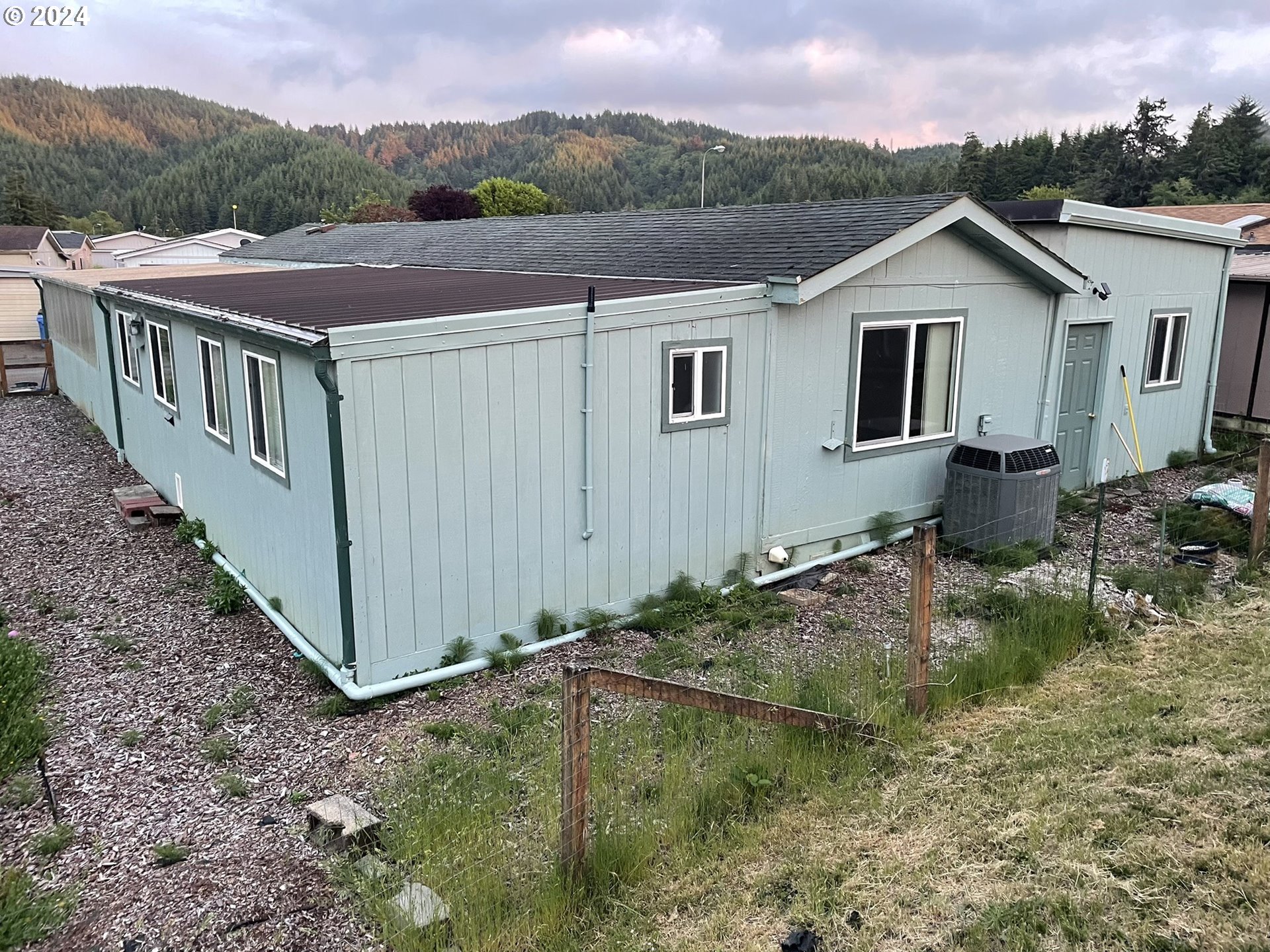 100 River Bend Road, Unit 5 Reedsport, OR 97467 - Photo 13 of 18 a view of a house with a yard