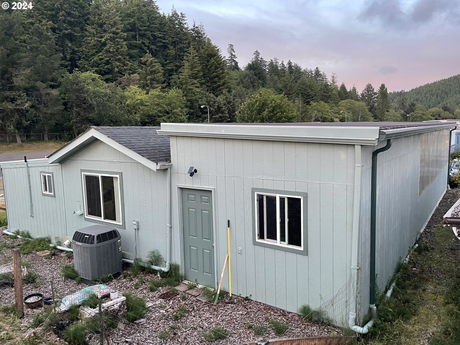 100 River Bend Road, Unit 5 Reedsport, OR 97467 - Photo 14 of 18 a house with trees in the background