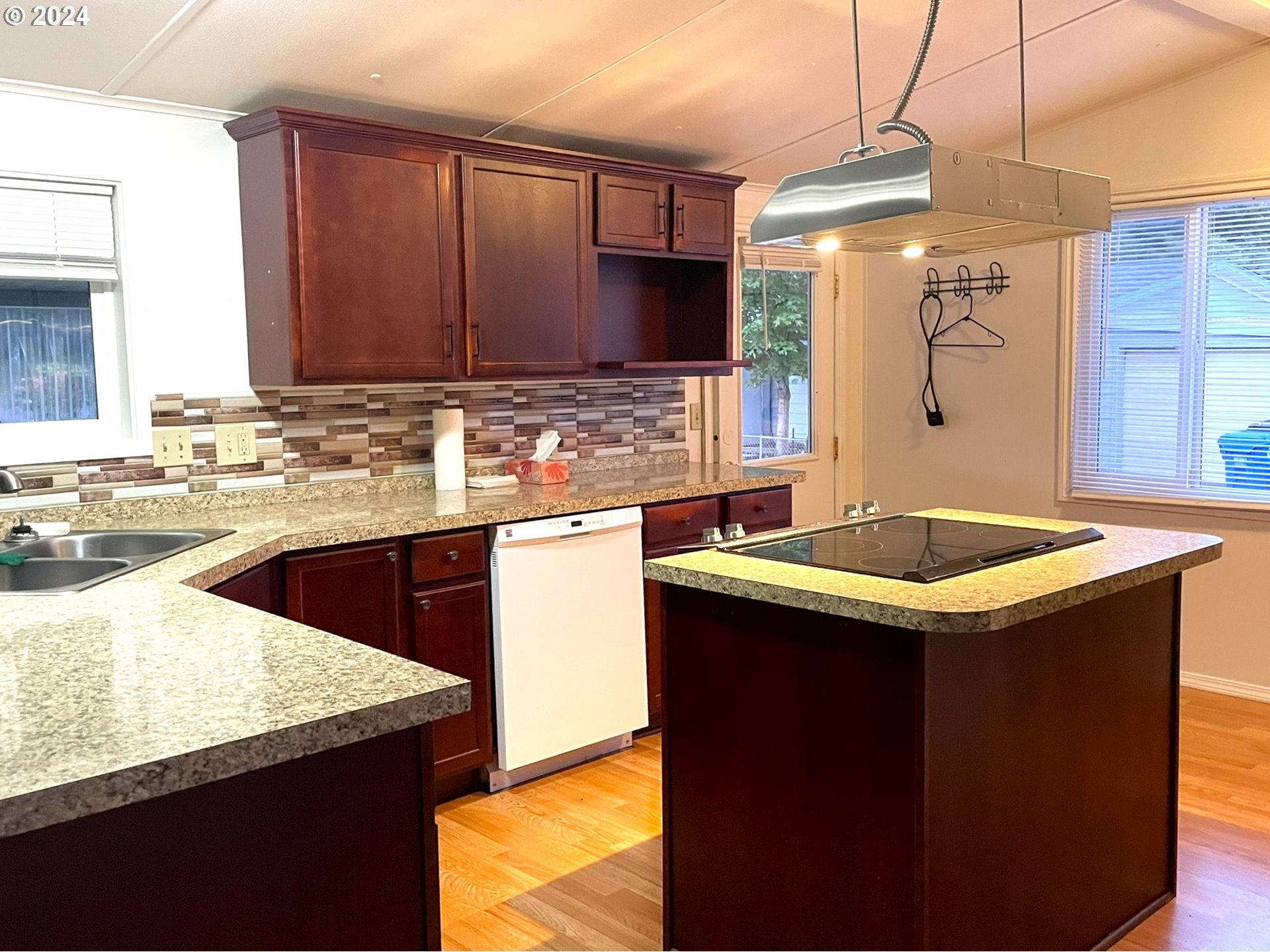100 River Bend Road, Unit 5 Reedsport, OR 97467 - Photo 2 of 18 a kitchen with a sink a stove and a refrigerator