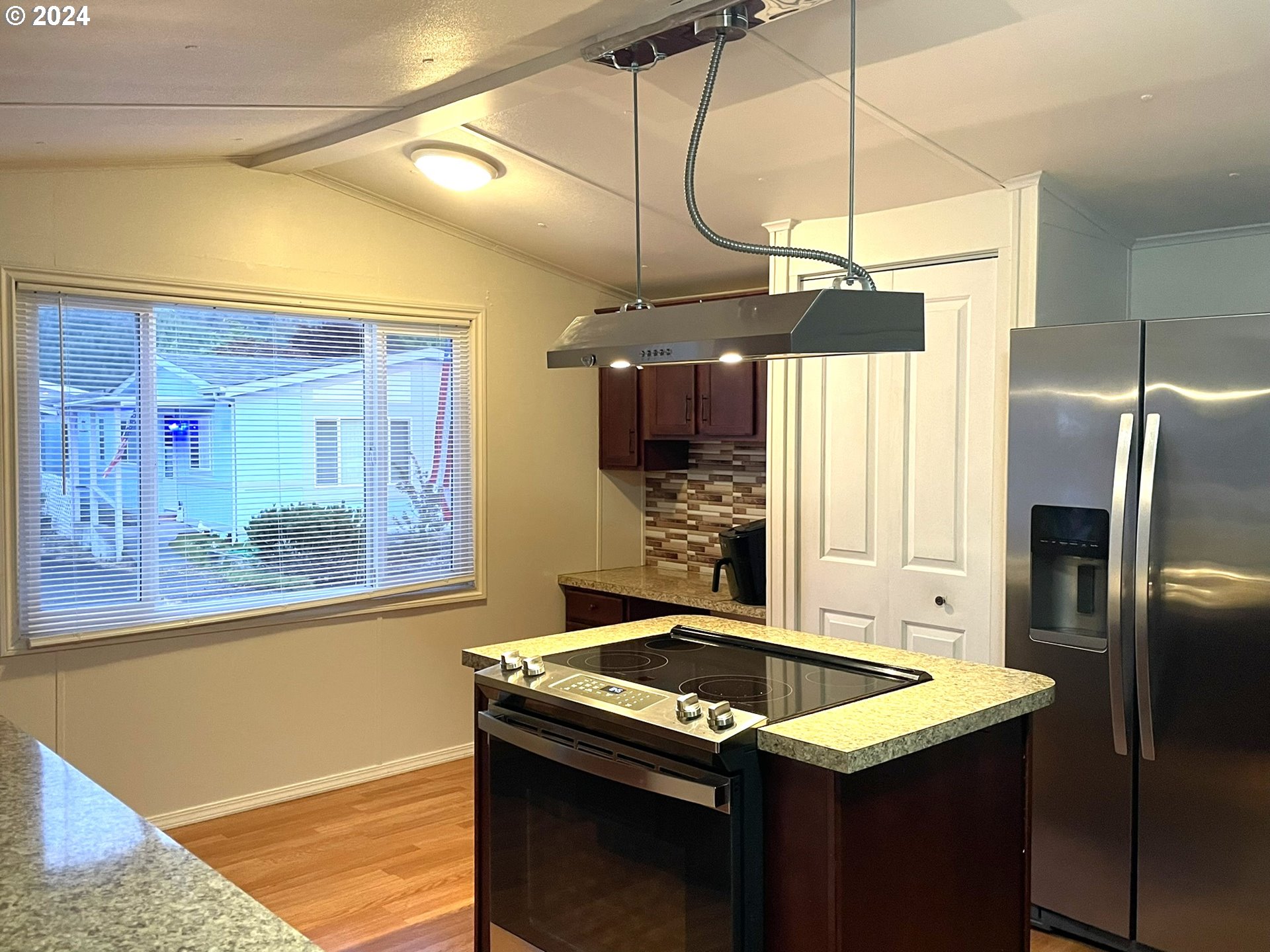 100 River Bend Road, Unit 5 Reedsport, OR 97467 - Photo 4 of 18 a kitchen that has a sink a stove and a refrigerator