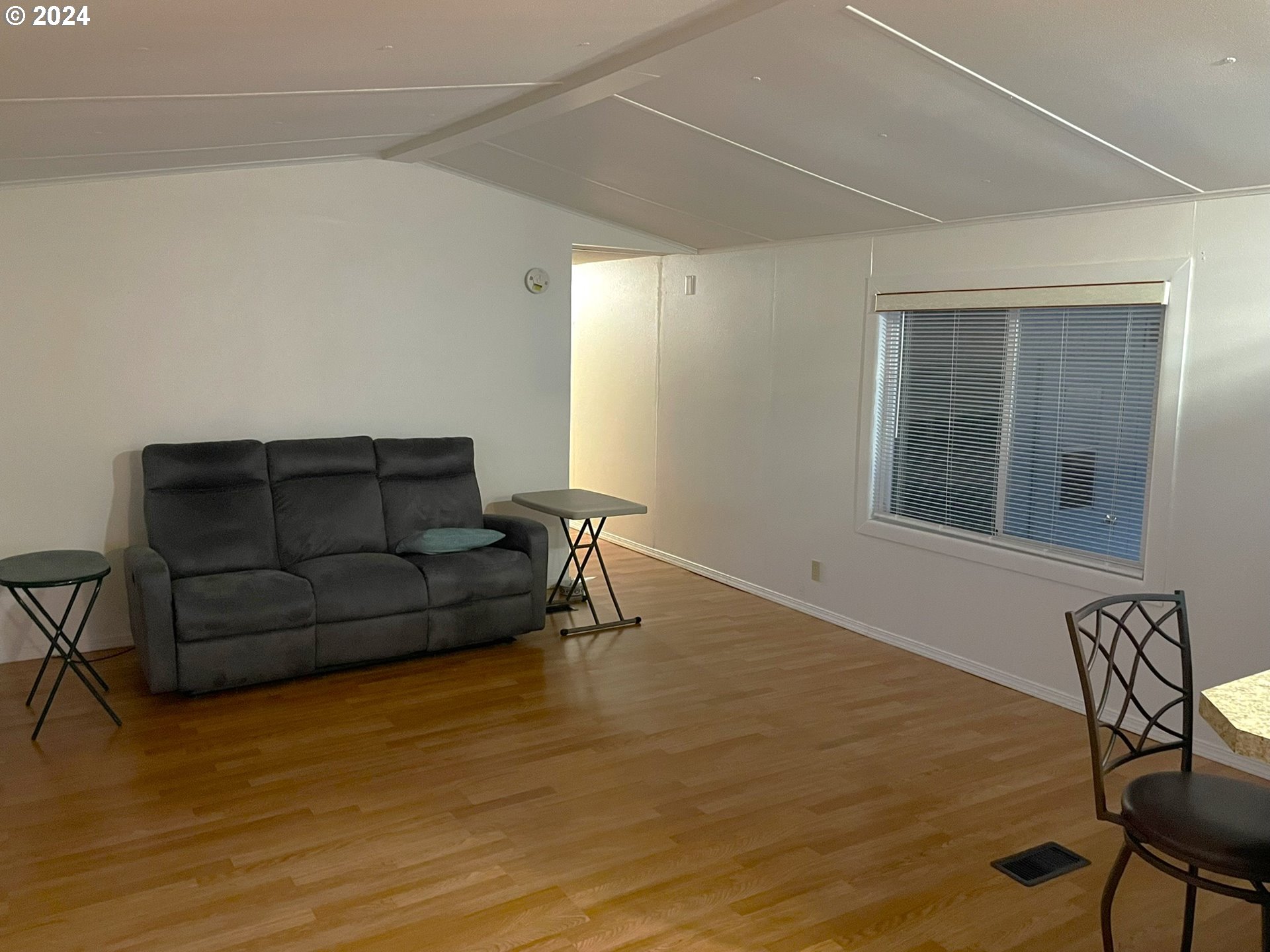 100 River Bend Road, Unit 5 Reedsport, OR 97467 - Photo 5 of 18 a living room with furniture and a window