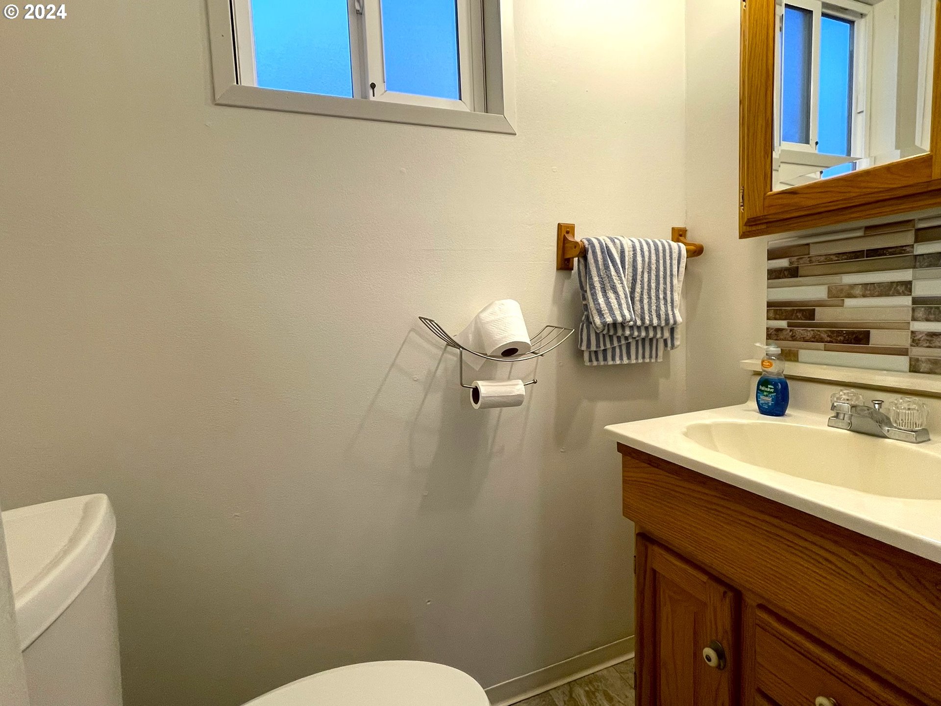 100 River Bend Road, Unit 5 Reedsport, OR 97467 - Photo 8 of 18 a bathroom with a sink a toilet and mirror