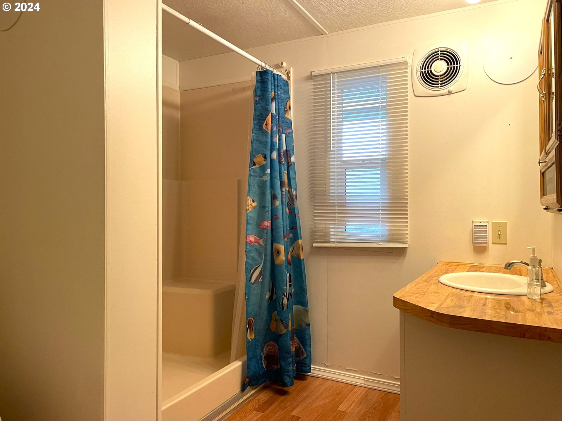 100 River Bend Road, Unit 5 Reedsport, OR 97467 - Photo 9 of 18 a bathroom with a sink and a mirror