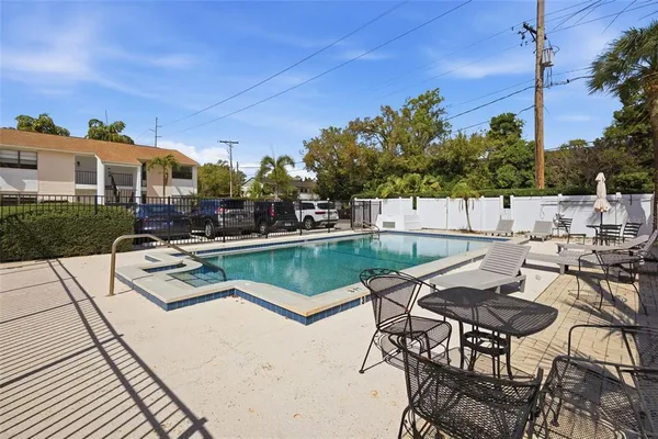 a view of a patio with chairs next to a yard