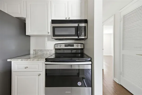 a kitchen with a stove and a microwave