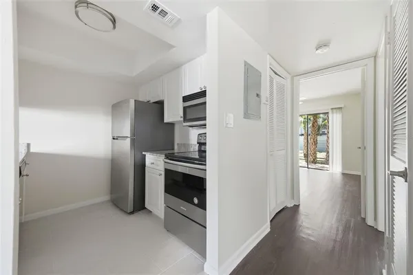 a kitchen with cabinets and stainless steel appliances