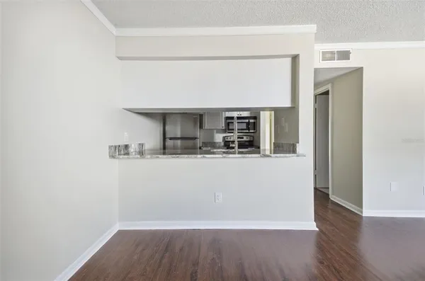 a room with a wooden floor and a hallway