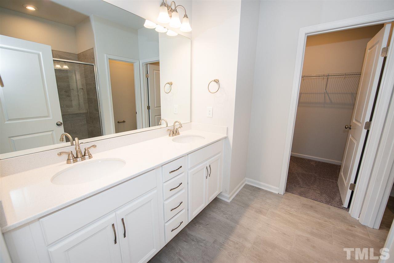 3610 Water Mist Lane, Unit 30 Raleigh, NC 27604 - Photo 13 of 25 a bathroom with a double vanity sink and a mirror