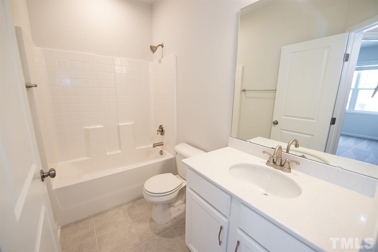 3610 Water Mist Lane, Unit 30 Raleigh, NC 27604 - Photo 17 of 25 a bathroom with a sink a toilet and bathtub