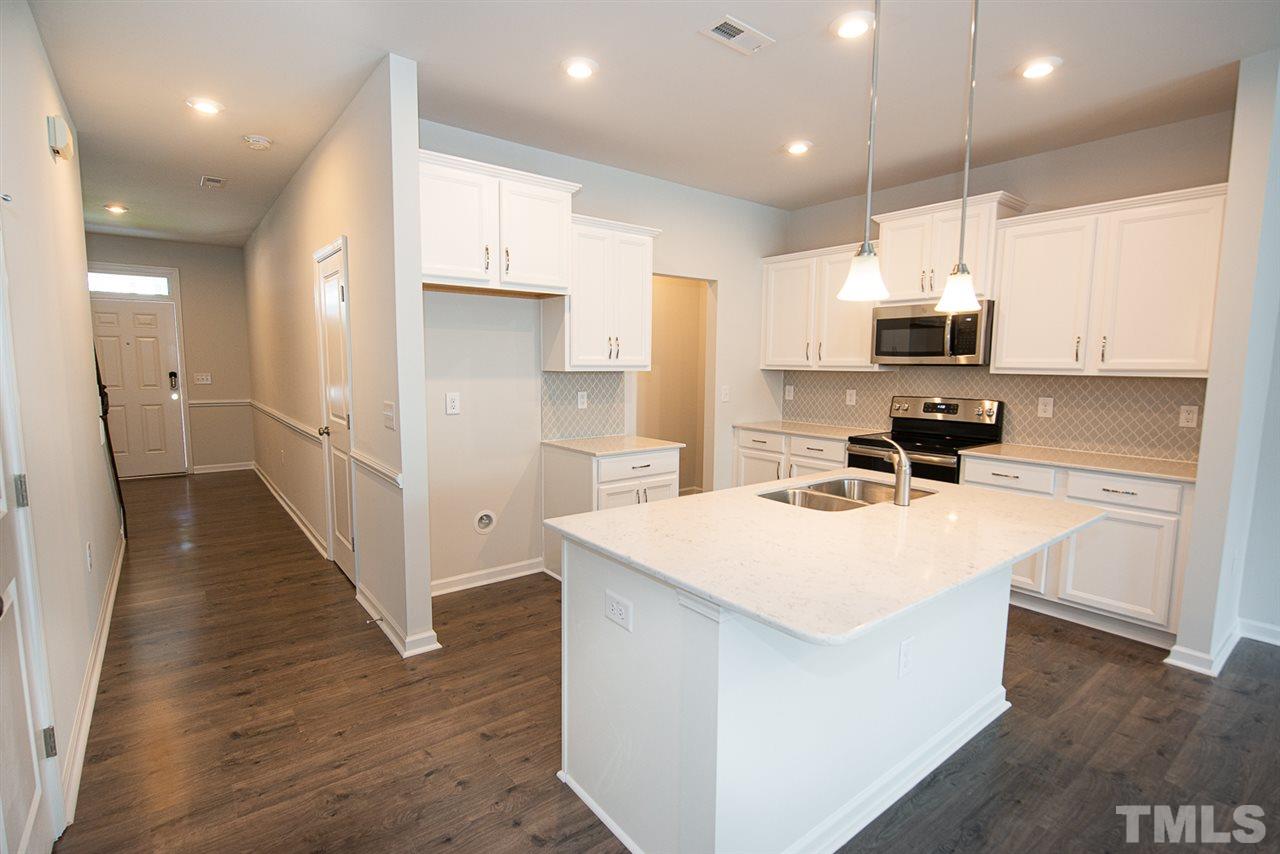 3610 Water Mist Lane, Unit 30 Raleigh, NC 27604 - Photo 6 of 25 a kitchen with stainless steel appliances a refrigerator and a stove top oven