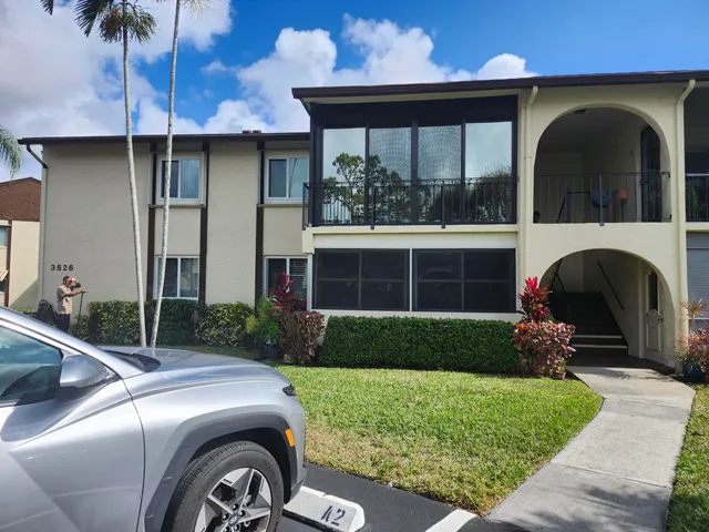 a front view of a house with a garden and plants