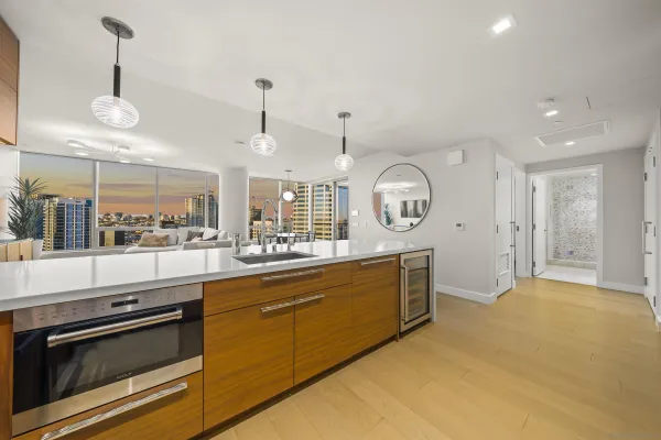 a large kitchen with stainless steel appliances granite countertop a stove a sink and a large window