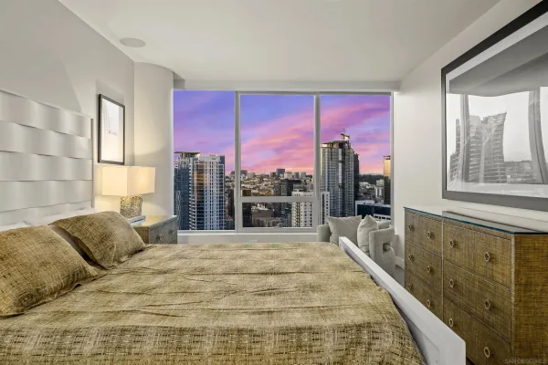 a spacious bedroom with a large bed and a dresser