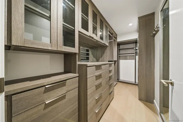 a view of walk in closet and empty room