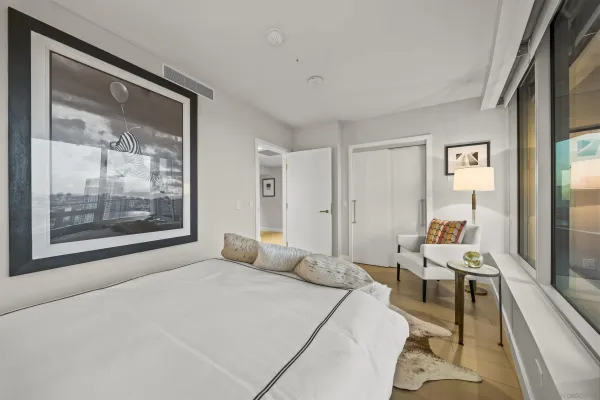 a bedroom with a large bed and a large window