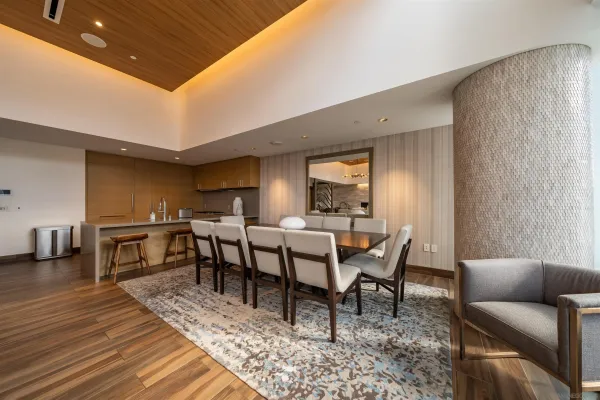a living room with furniture a desk and chair with wooden floor