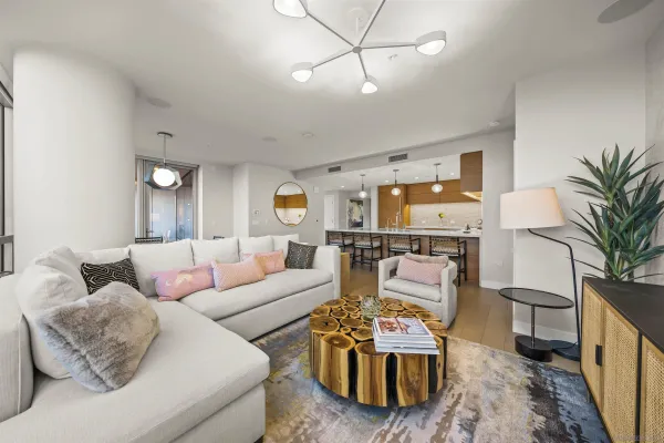 a living room with furniture and a chandelier