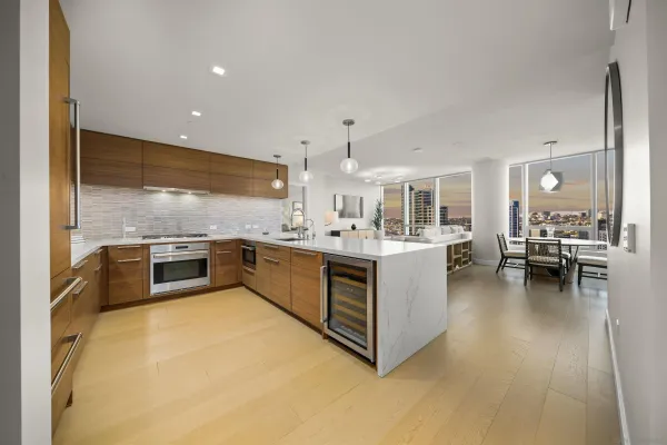a large white kitchen with a large window