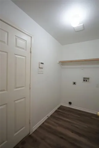 a view of a small space with wooden floor and a window