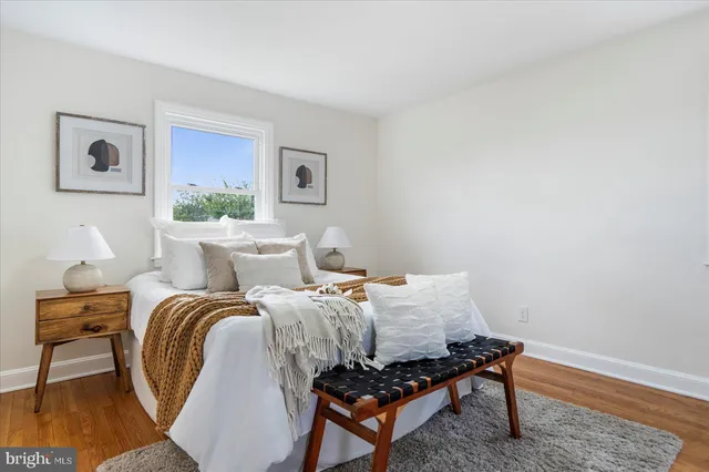 a bed room with a bed and a chair