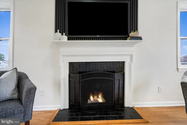 a living room with a fireplace and a flat screen tv