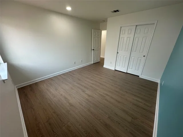 an empty room with wooden floor