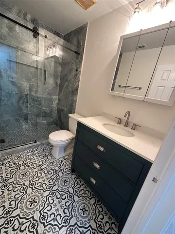 a bathroom with a sink toilet and shower