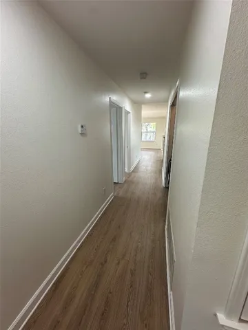 a view of hallway with wooden floor
