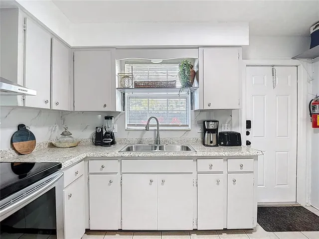a kitchen with stainless steel appliances a sink and cabinets