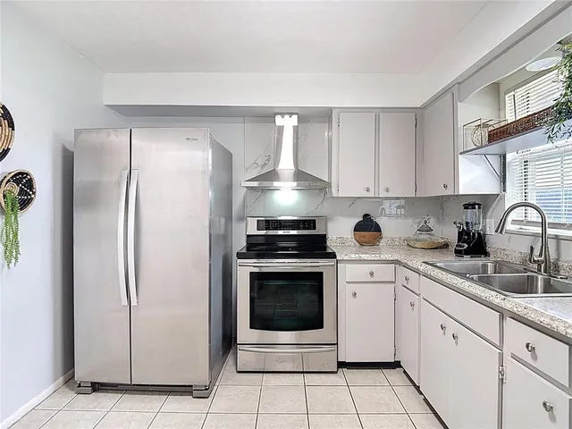 a room with a flat screen tv and furniture