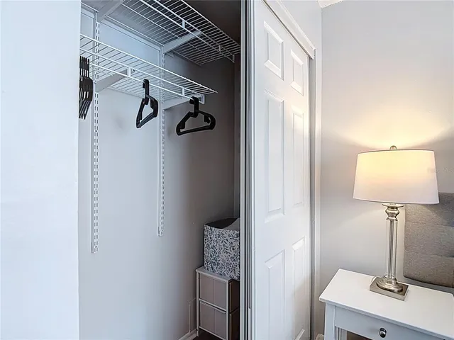 a bedroom with a bed and a lamp