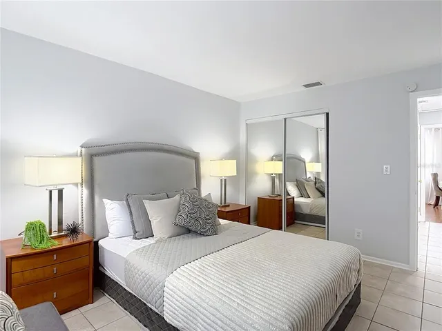 a bedroom with a bed and a lamp