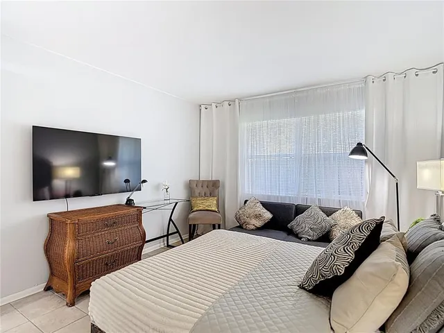 a bathroom with a sink a toilet and shower curtain