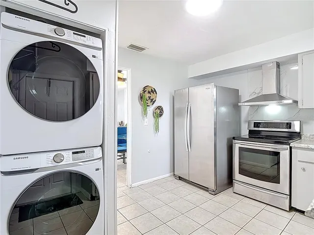 a view of a backyard with a tub and wooden fence