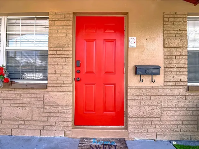 a living room with furniture and a dining table with kitchen view