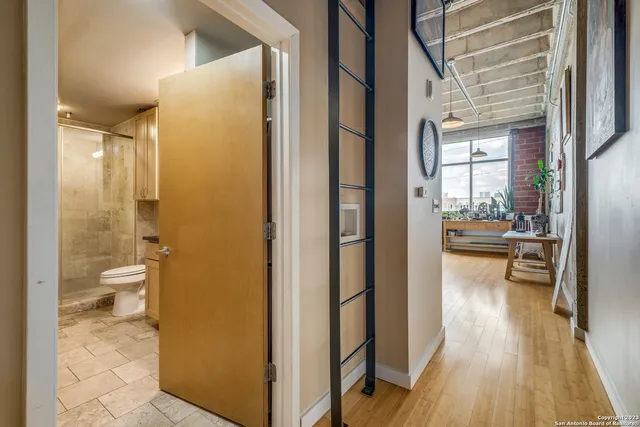 a bathroom with a granite countertop shower a sink and a toilet