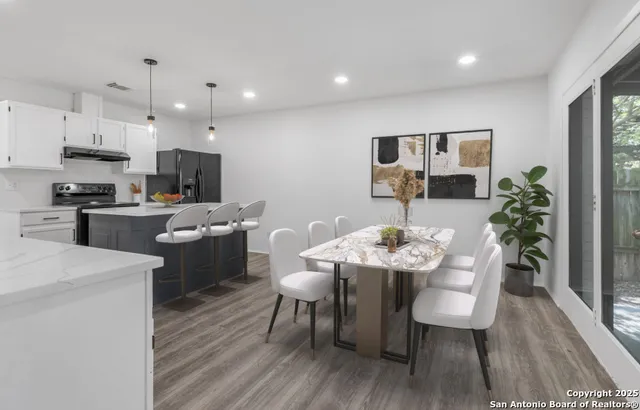 a view of kitchen with furniture and wooden floor