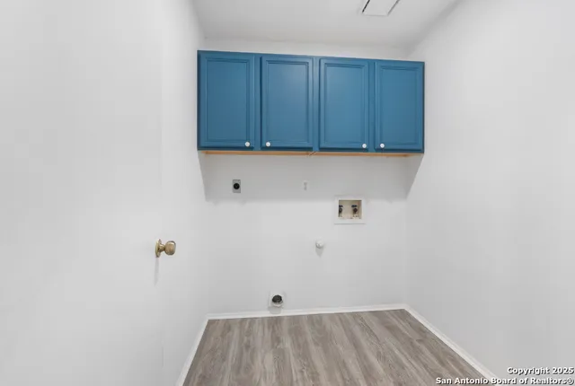 a view of storage and utility room with wooden floor