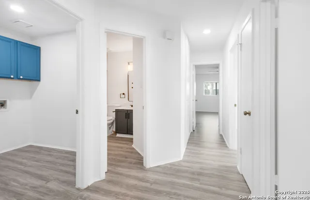 a view of a hallway with wooden floor