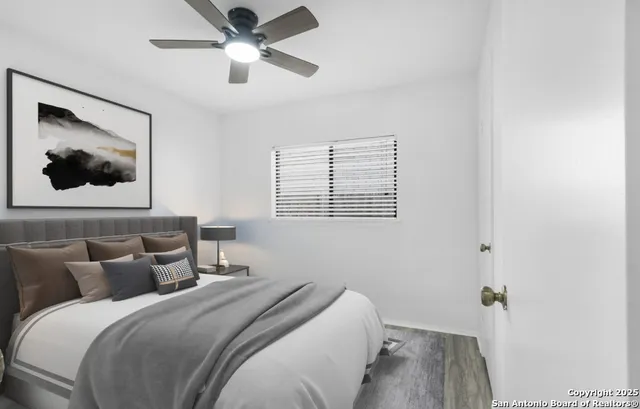 a bedroom with a bed and a painting on the wall