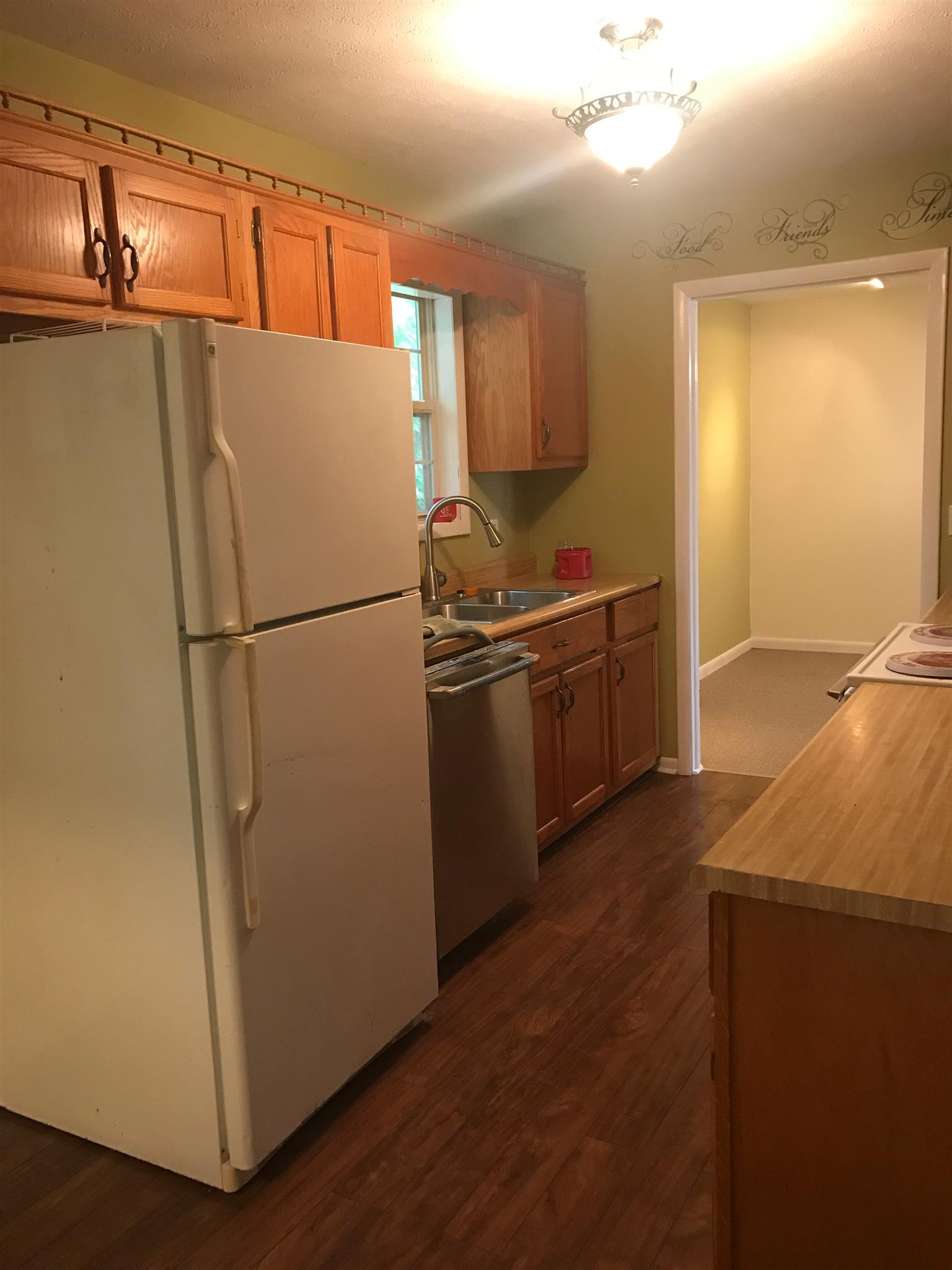 88 Redbud Road Red Boiling Springs, TN 37150 - Photo 5 of 19 a white refrigerator freezer and a wooden floor