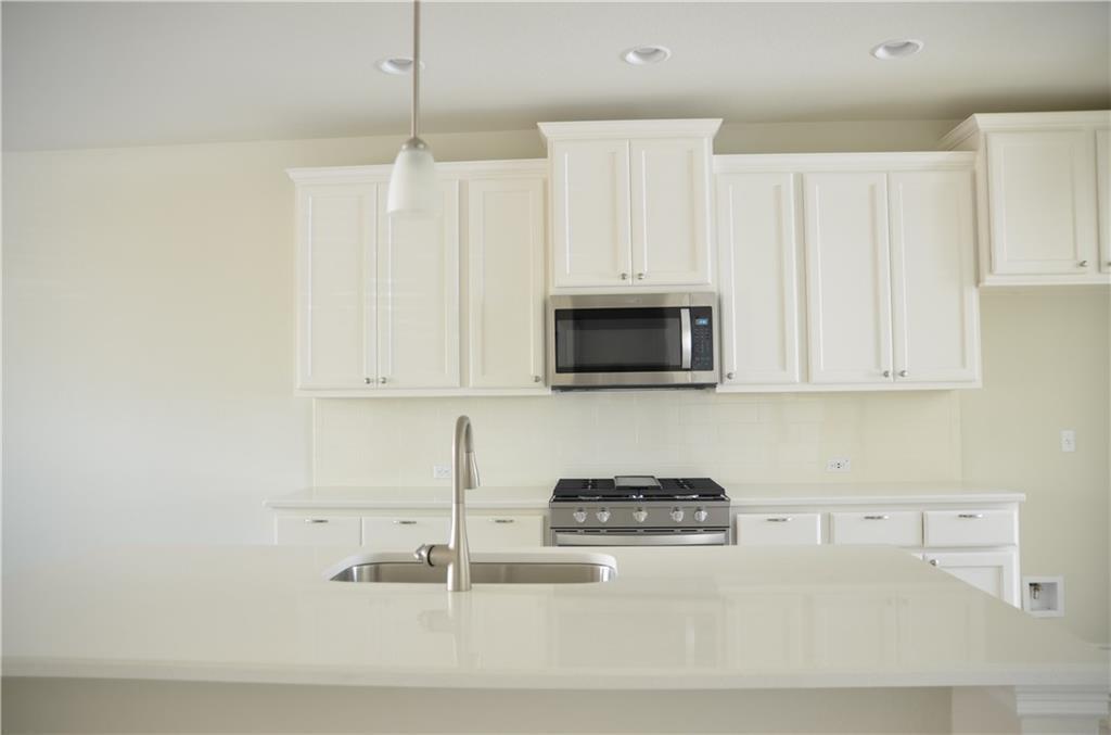 14403 McCoy Loop Austin, TX 78717 - Photo 6 of 29 Culinary aspirations come alive in this pristine kitchen, featuring modern appliances and ample counter space.