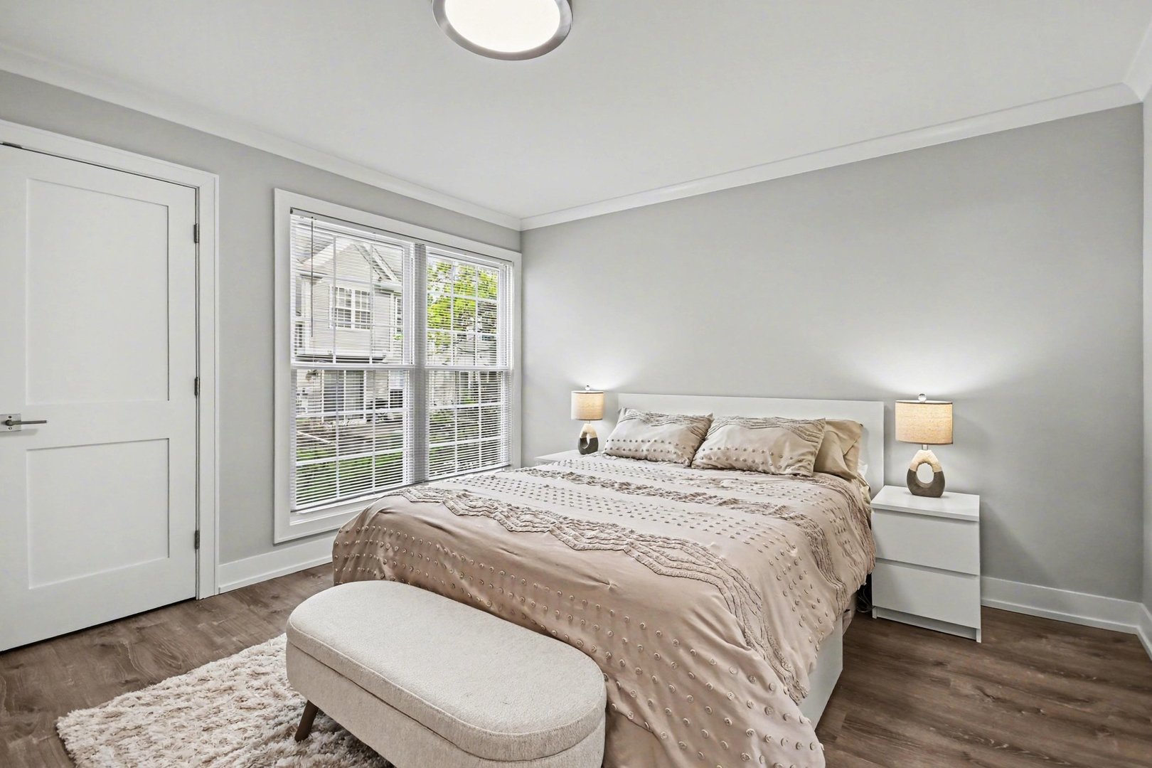 850 Spring Creek Court Elk Grove Village, IL 60007 - Photo 16 of 26 a spacious bedroom with a bed and wooden floor