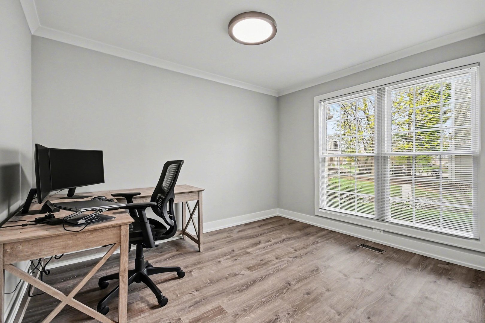 850 Spring Creek Court Elk Grove Village, IL 60007 - Photo 20 of 26 a view of a workspace with furniture and a window