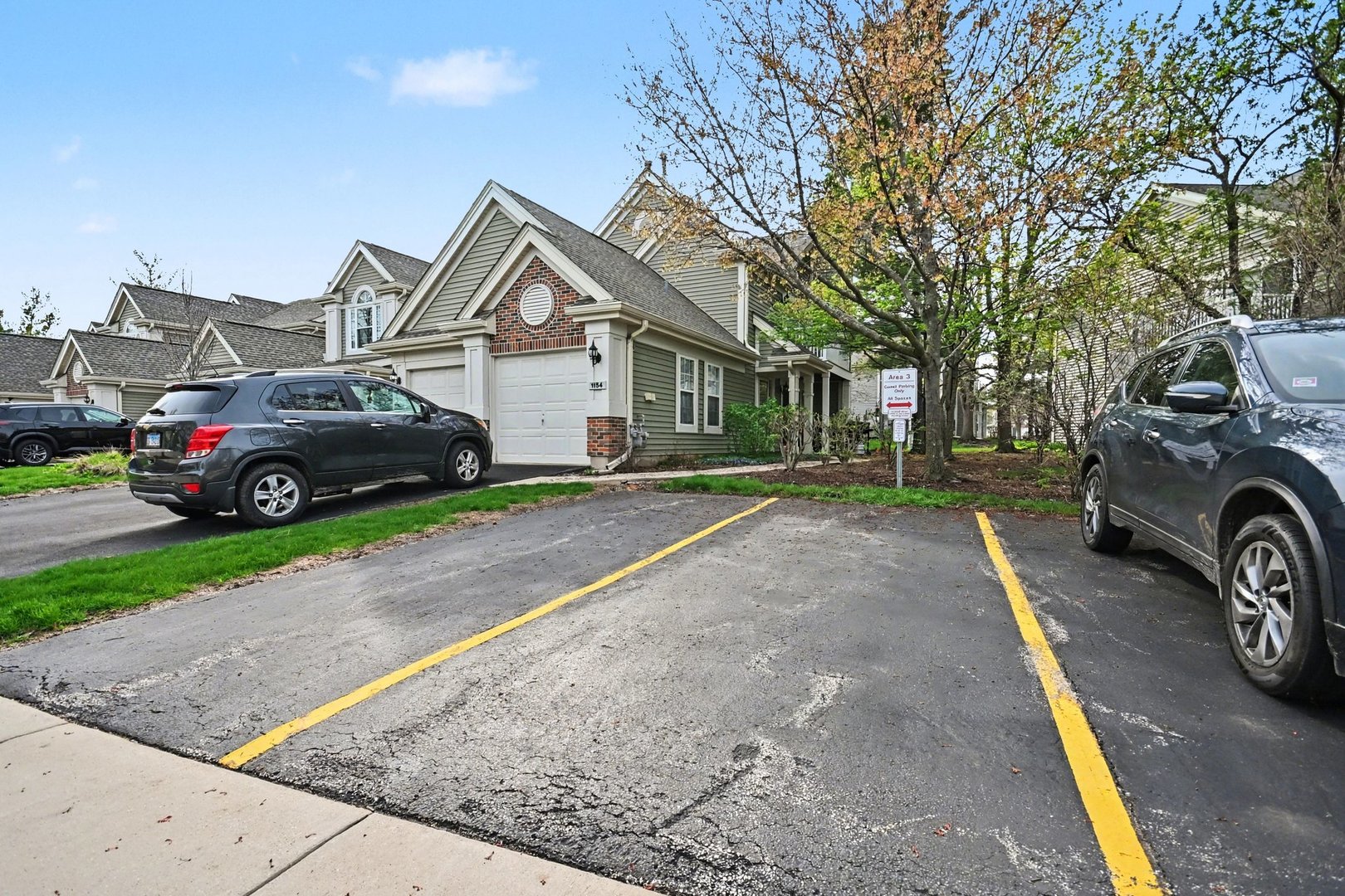 850 Spring Creek Court Elk Grove Village, IL 60007 - Photo 25 of 26 a front view of a house with a garden and parking space