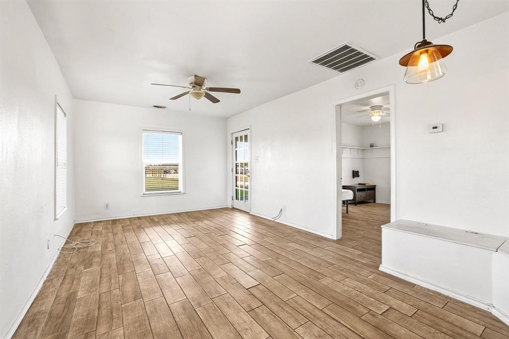 2092 County Road 5010 Blue Ridge, TX 75424 - Photo 12 of 28 wooden floor in an empty room with a window