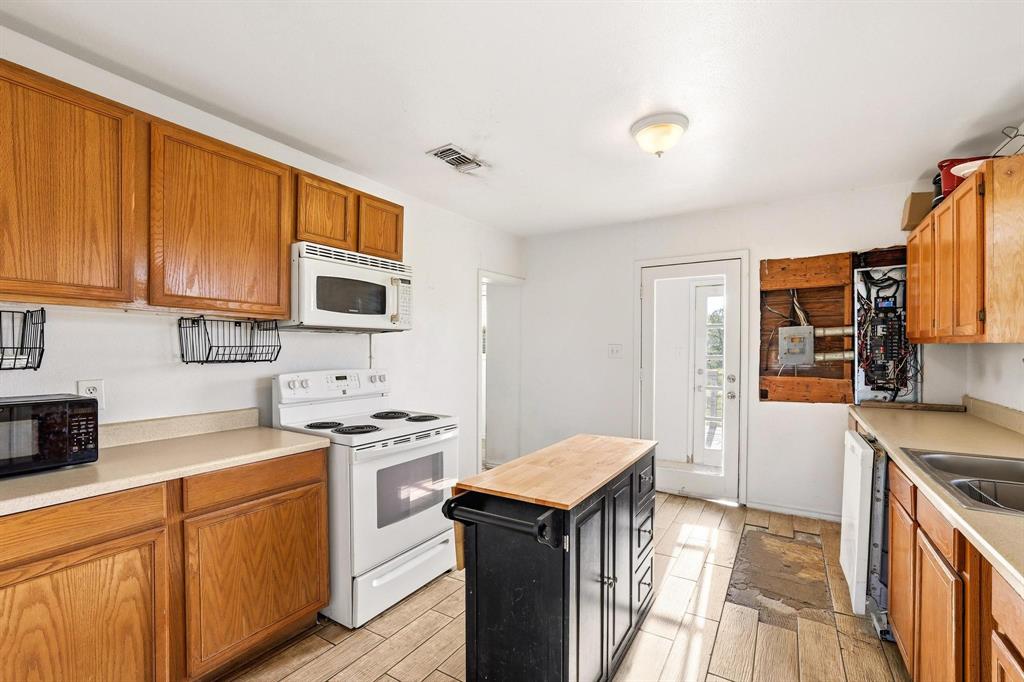 2092 County Road 5010 Blue Ridge, TX 75424 - Photo 13 of 28 a kitchen with stainless steel appliances granite countertop a sink stove and refrigerator